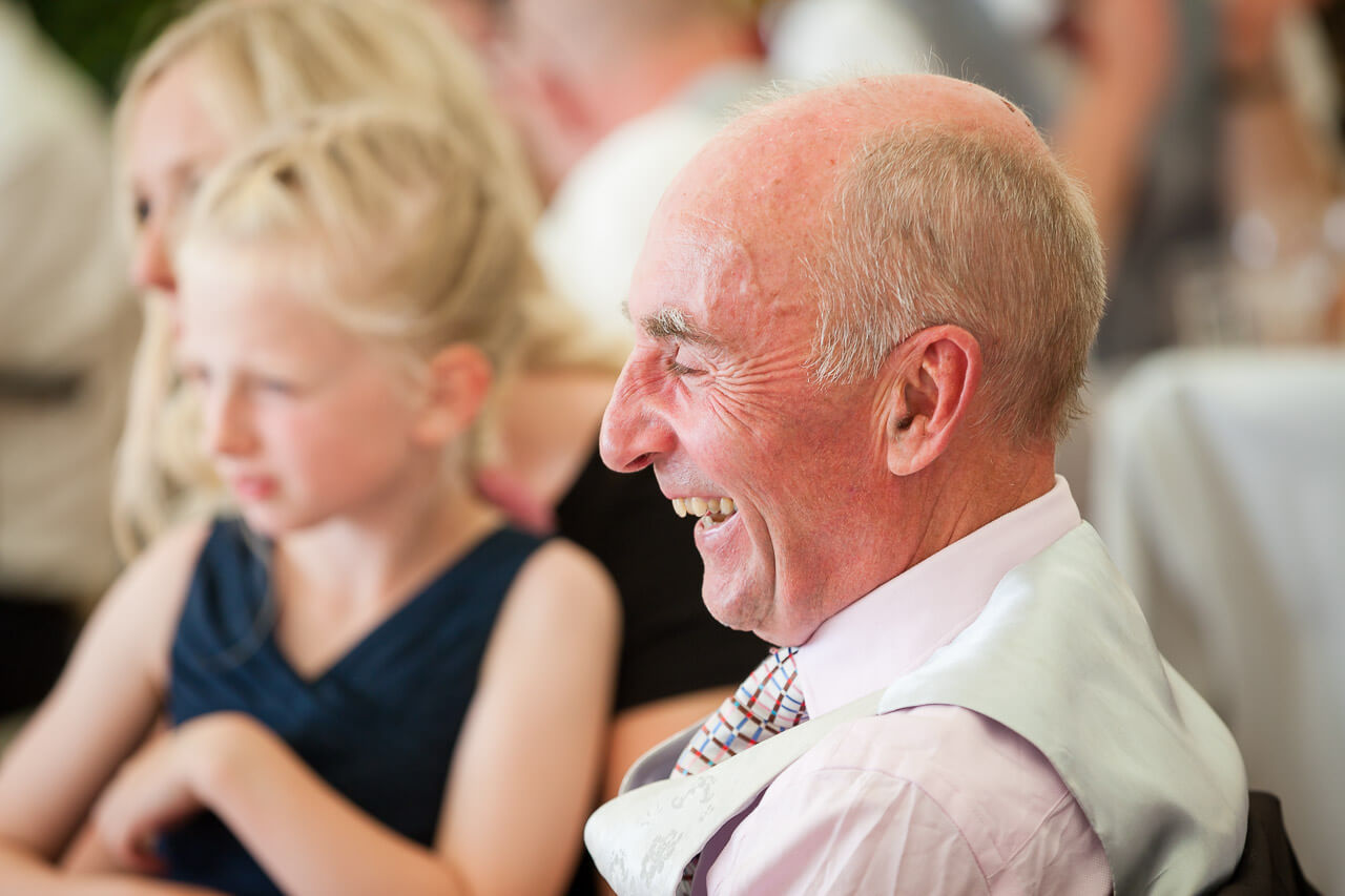father of the bride laughing at speeches