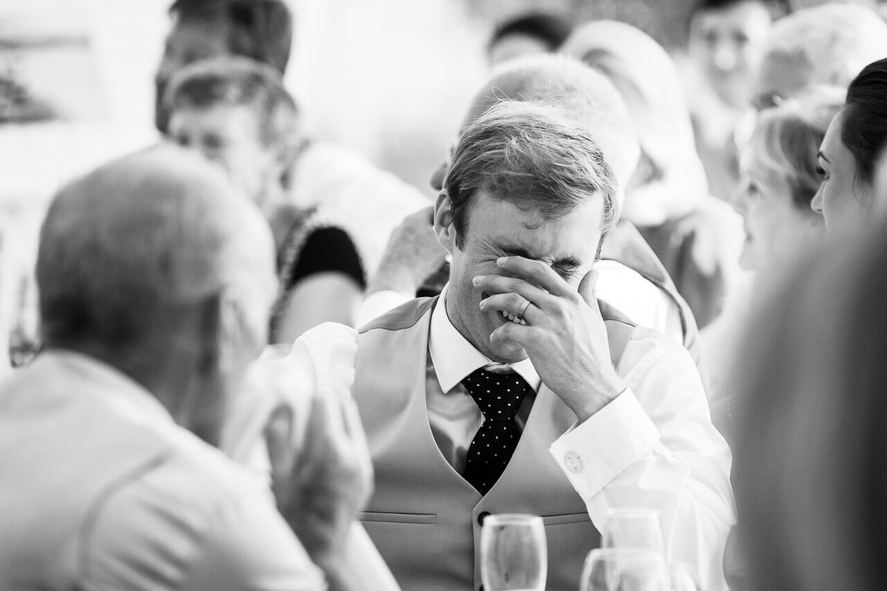 groom head in hand listening to speech