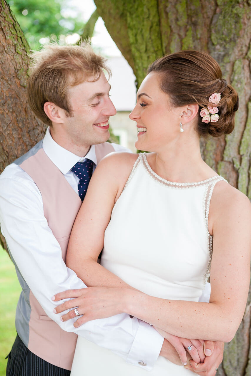 bride and groom looking at each other smiling