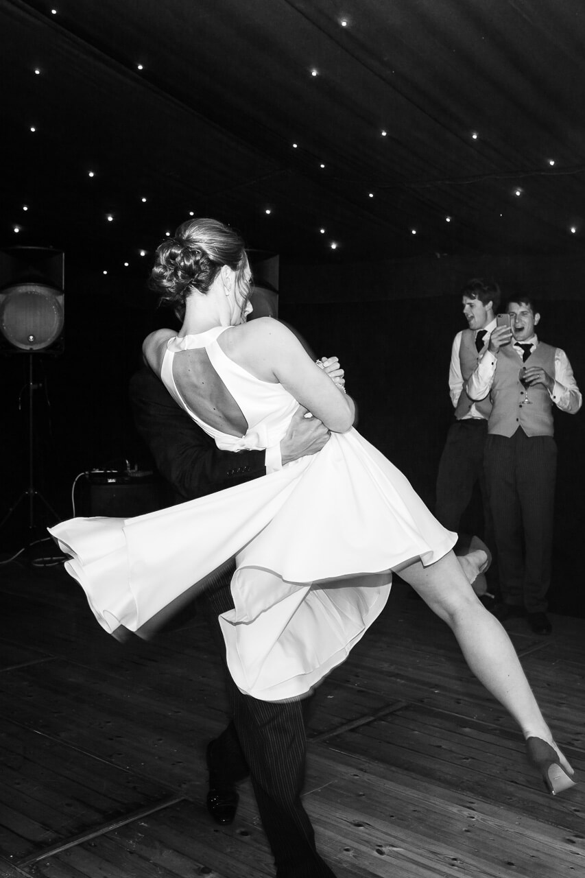 groom picking up bride spinning her around