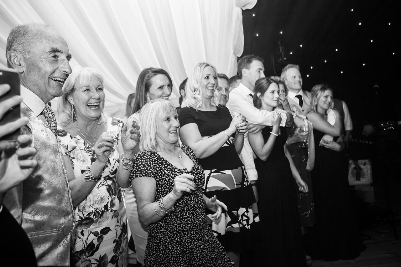 guests watching bride and groom dance