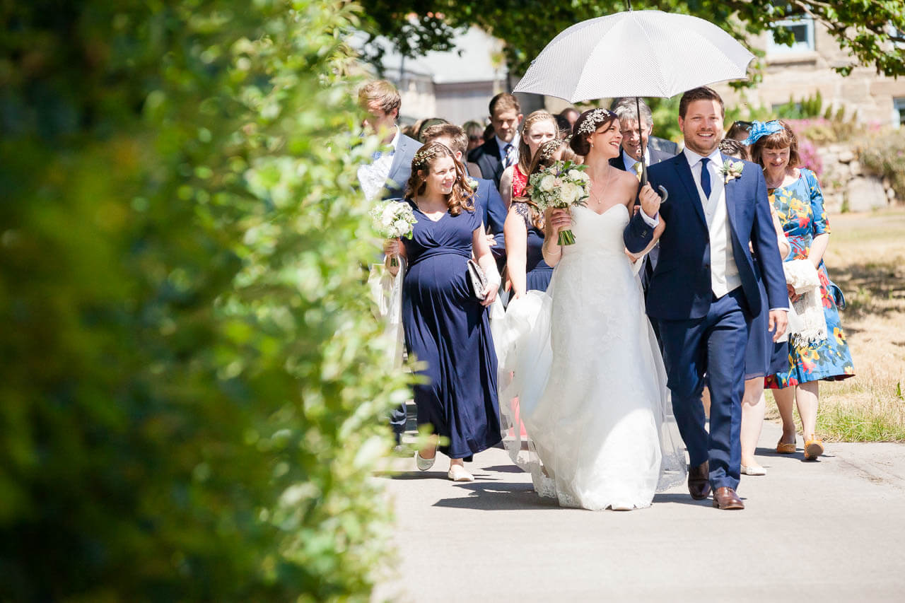 bride and groom walking to beach