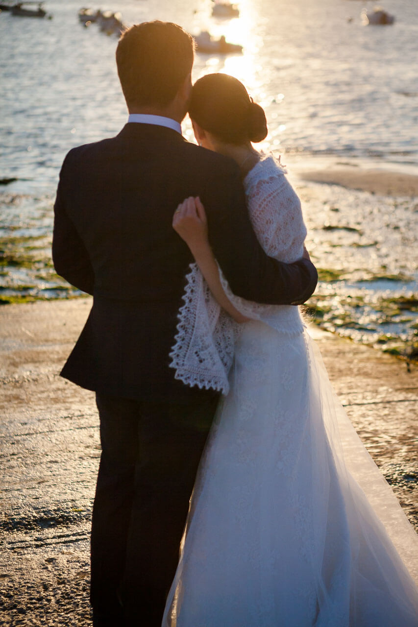 bride and groom watching sunset