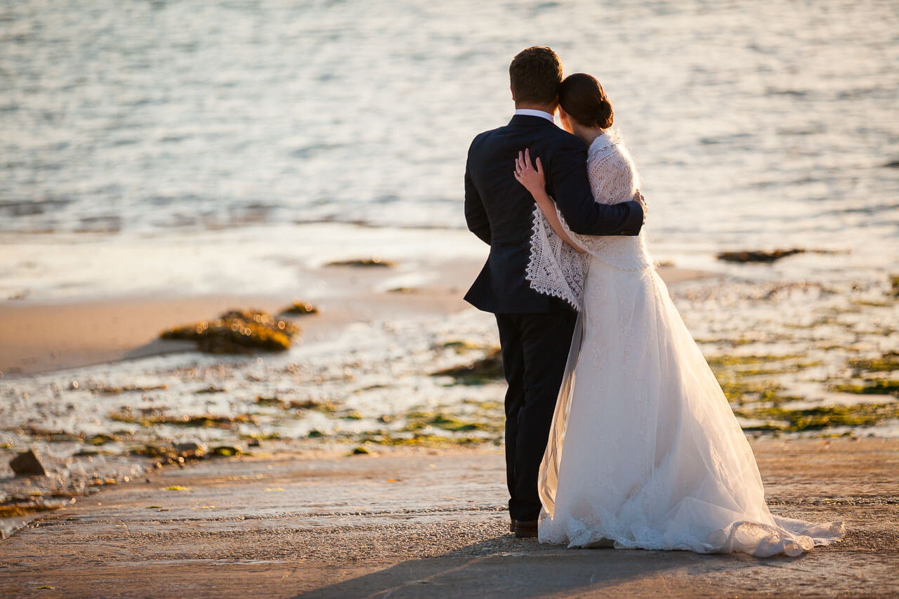 bride and groom watching sunset