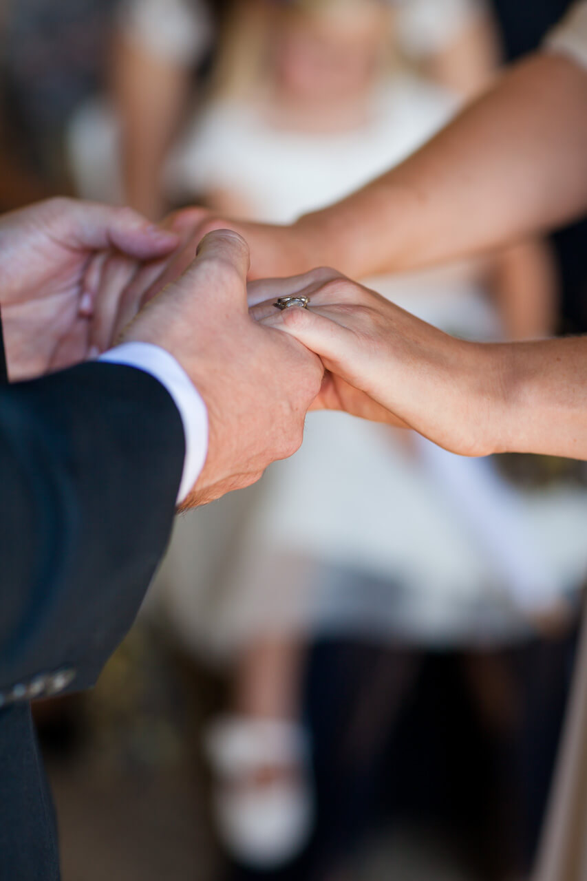 bride and groom linking hands