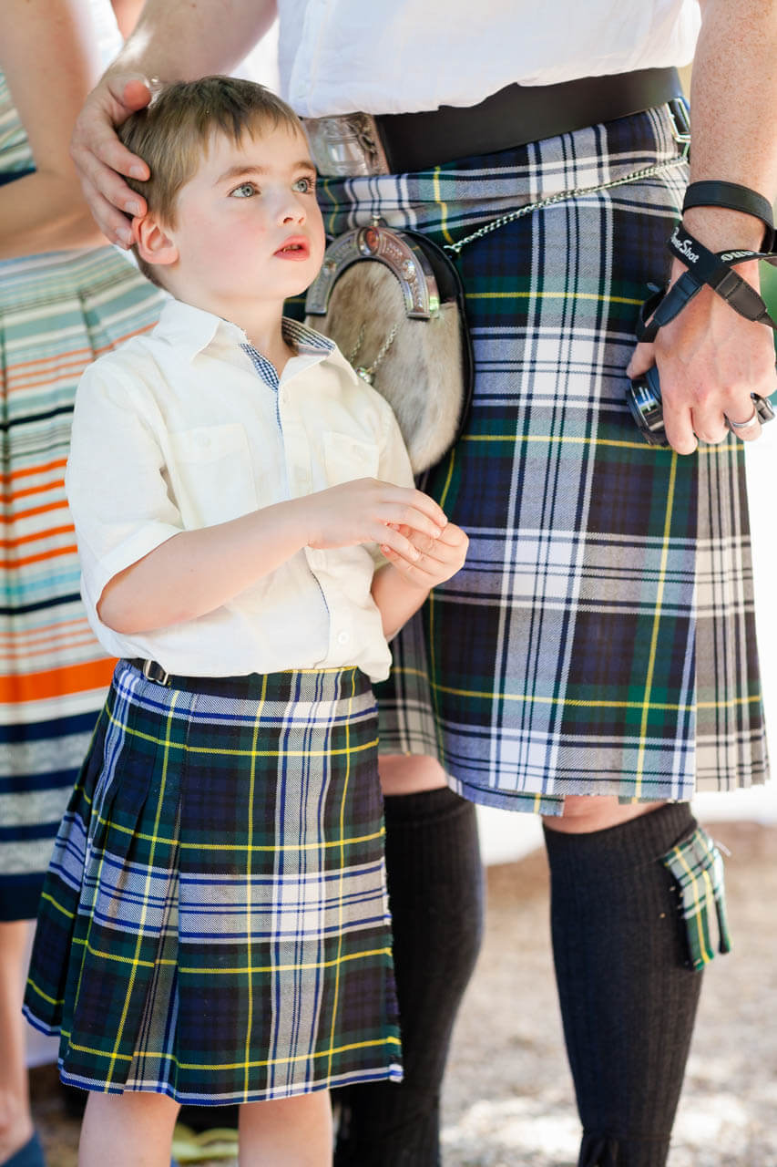 boy in kilt next to dad
