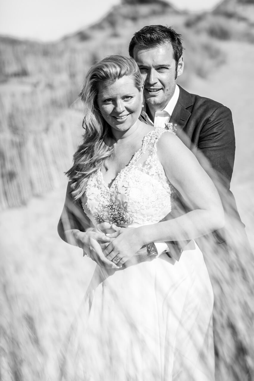 groom hugs bride from behind