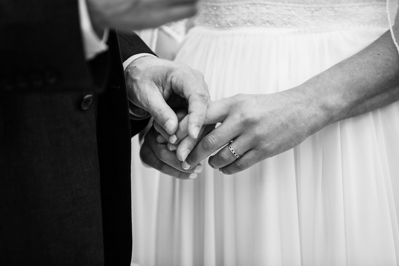 groom gently holds brides hand