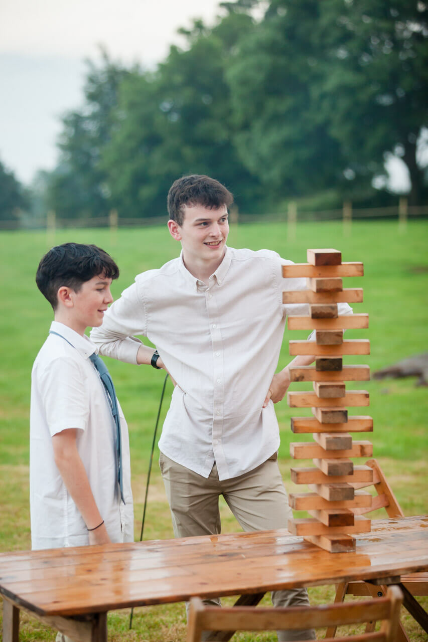 kids admire jenga stack