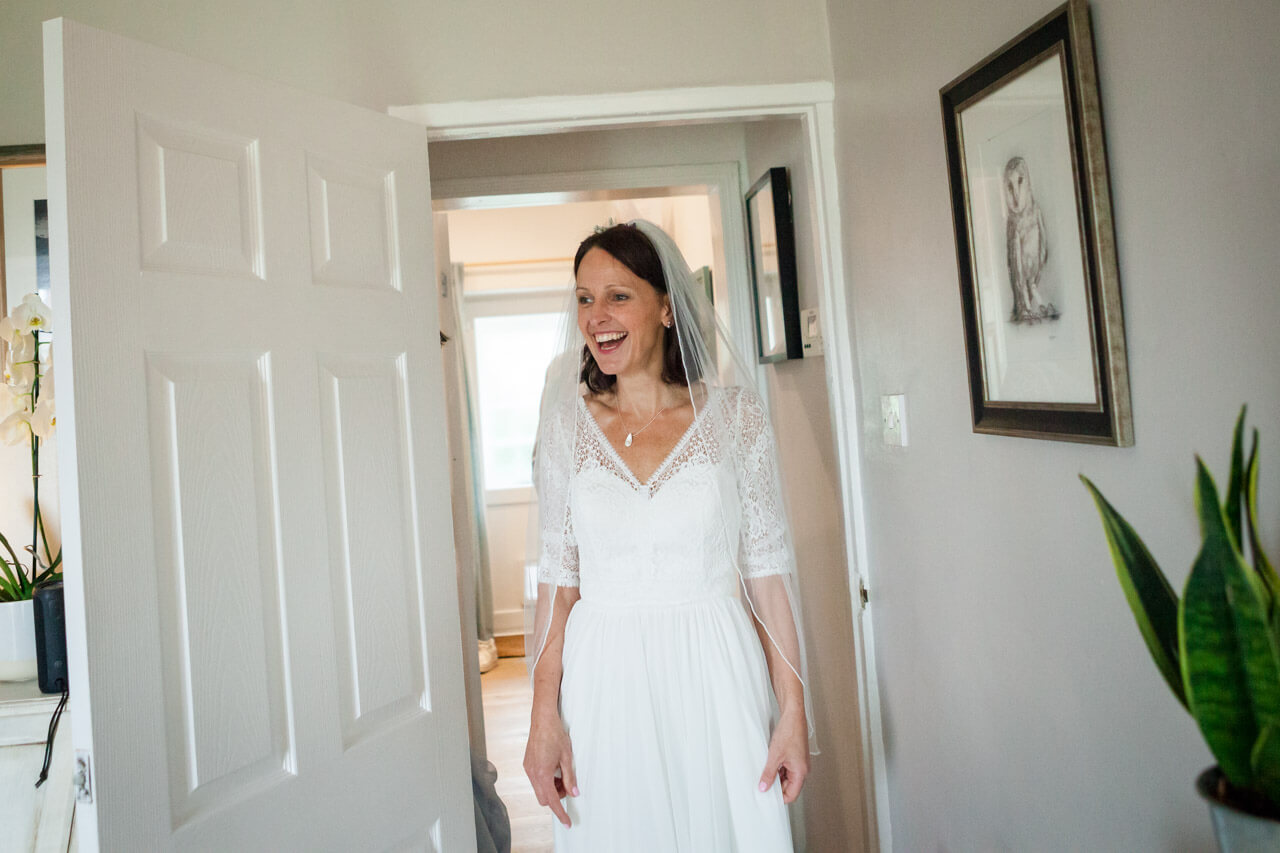 bride walking into sitting room where family see her for the first time
