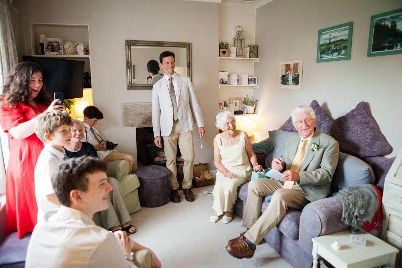family anticipate bride entering sitting room