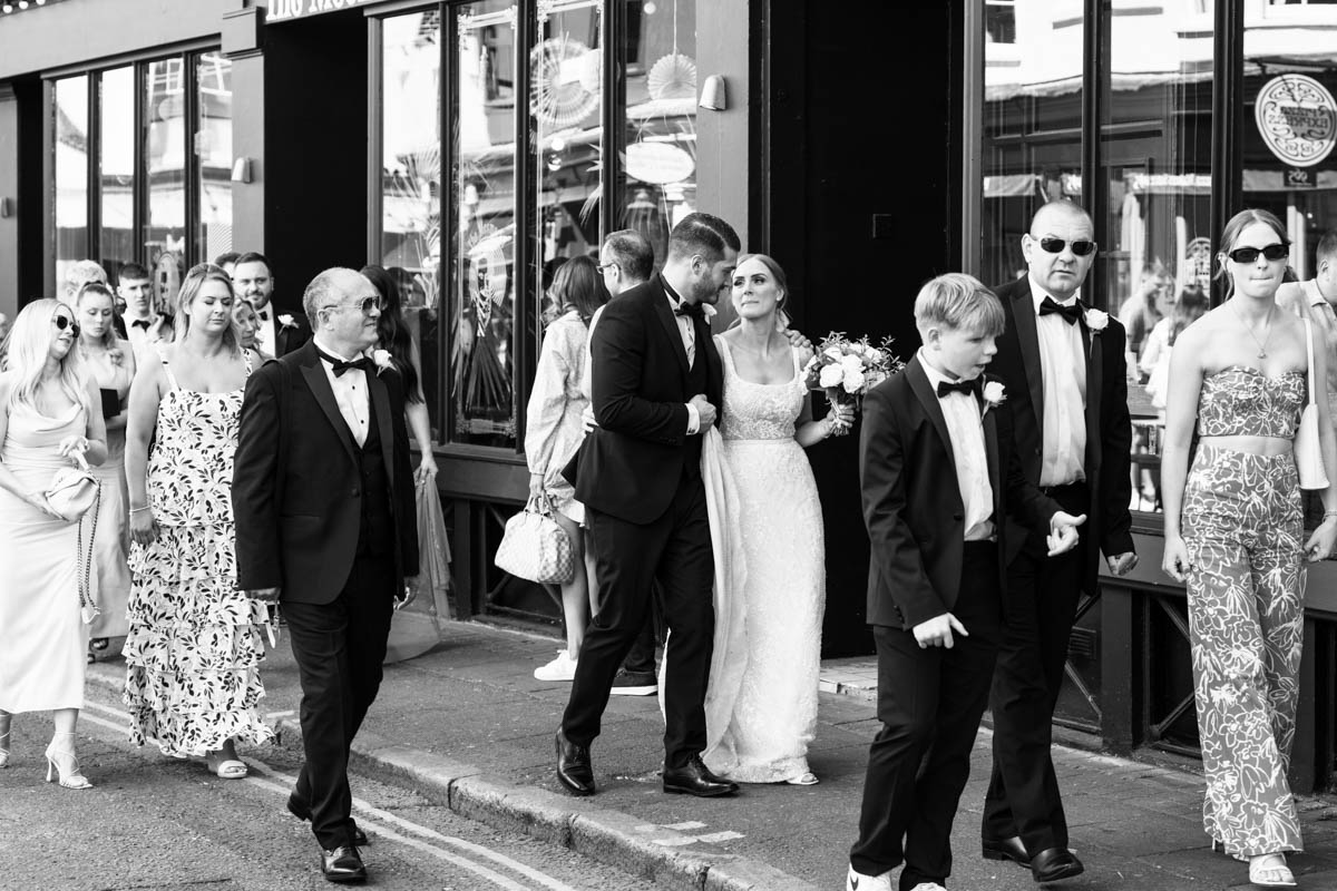 walking away from the town hall on a wedding party stroll through the north lanes