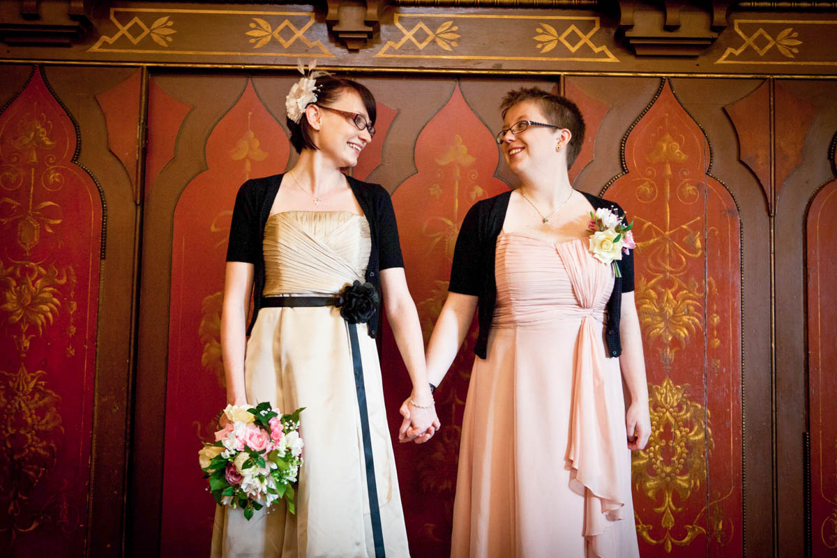brides holding hands looking at each other