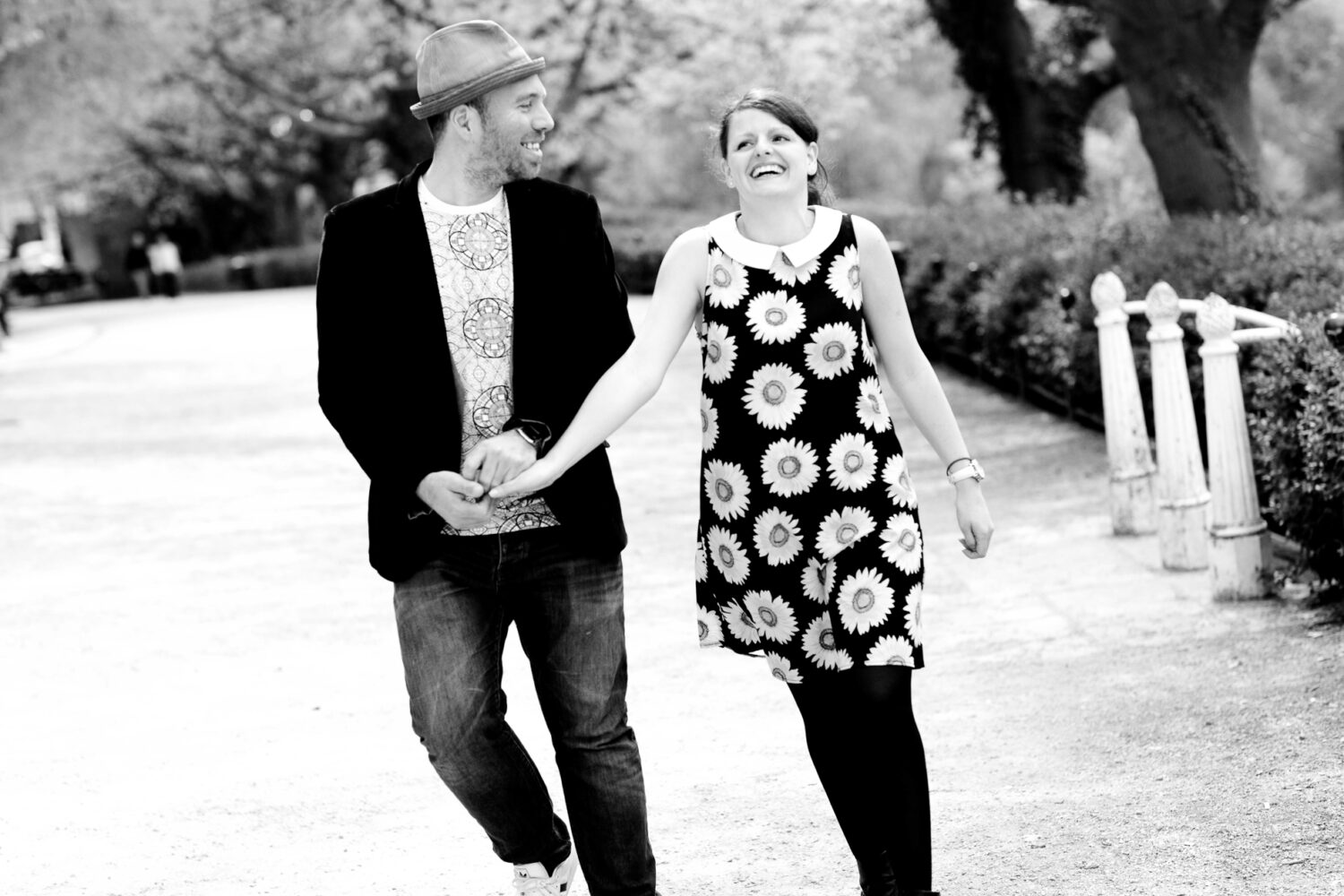  man and woman walking arm in arm laughing with each other 