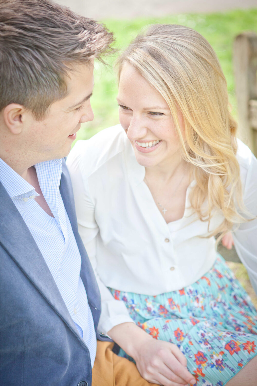 women looking into man's eyes sitting in park
