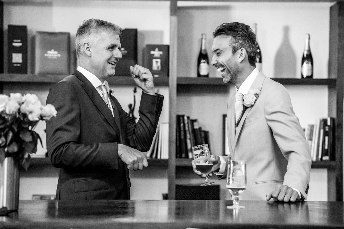 groom and best man sharing a joke before the wedding