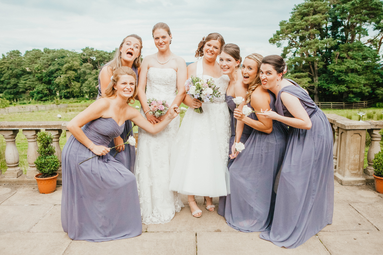 group shot of two brides with their bridesmaids