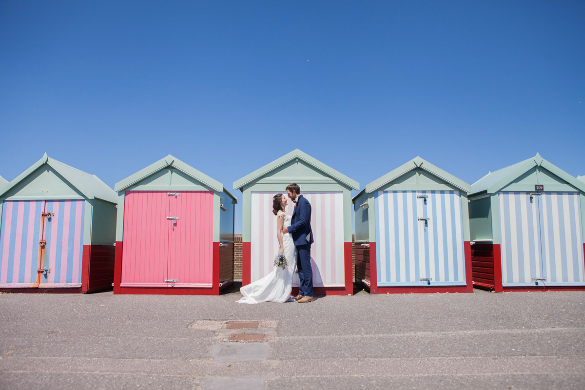 couple standing looking at each other outside beach buts in hove