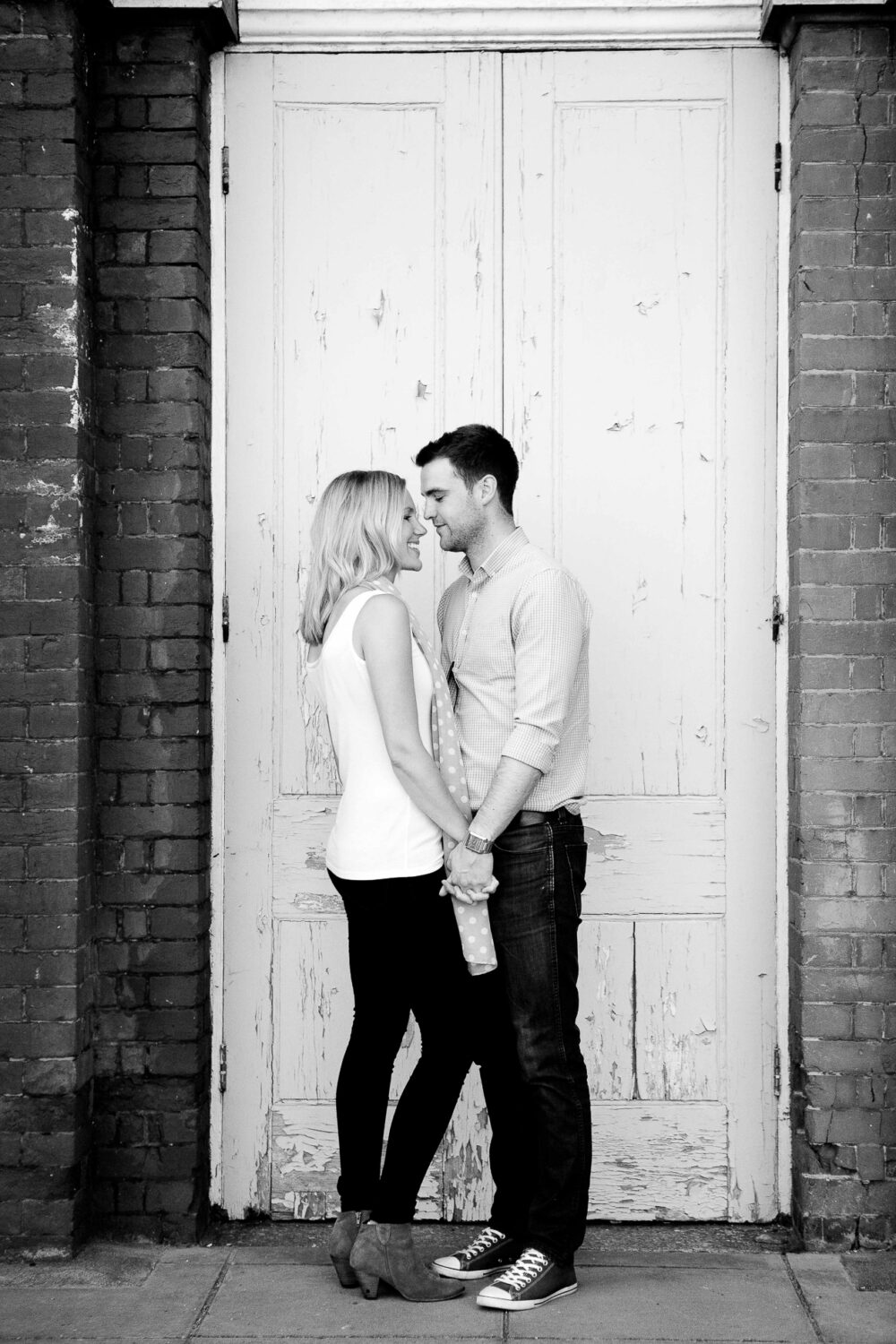 couple standing holding hands facing each other