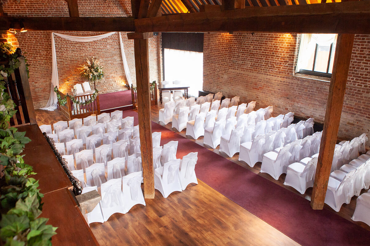 inside of cooling castle barn in ceremony room with chairs laid out