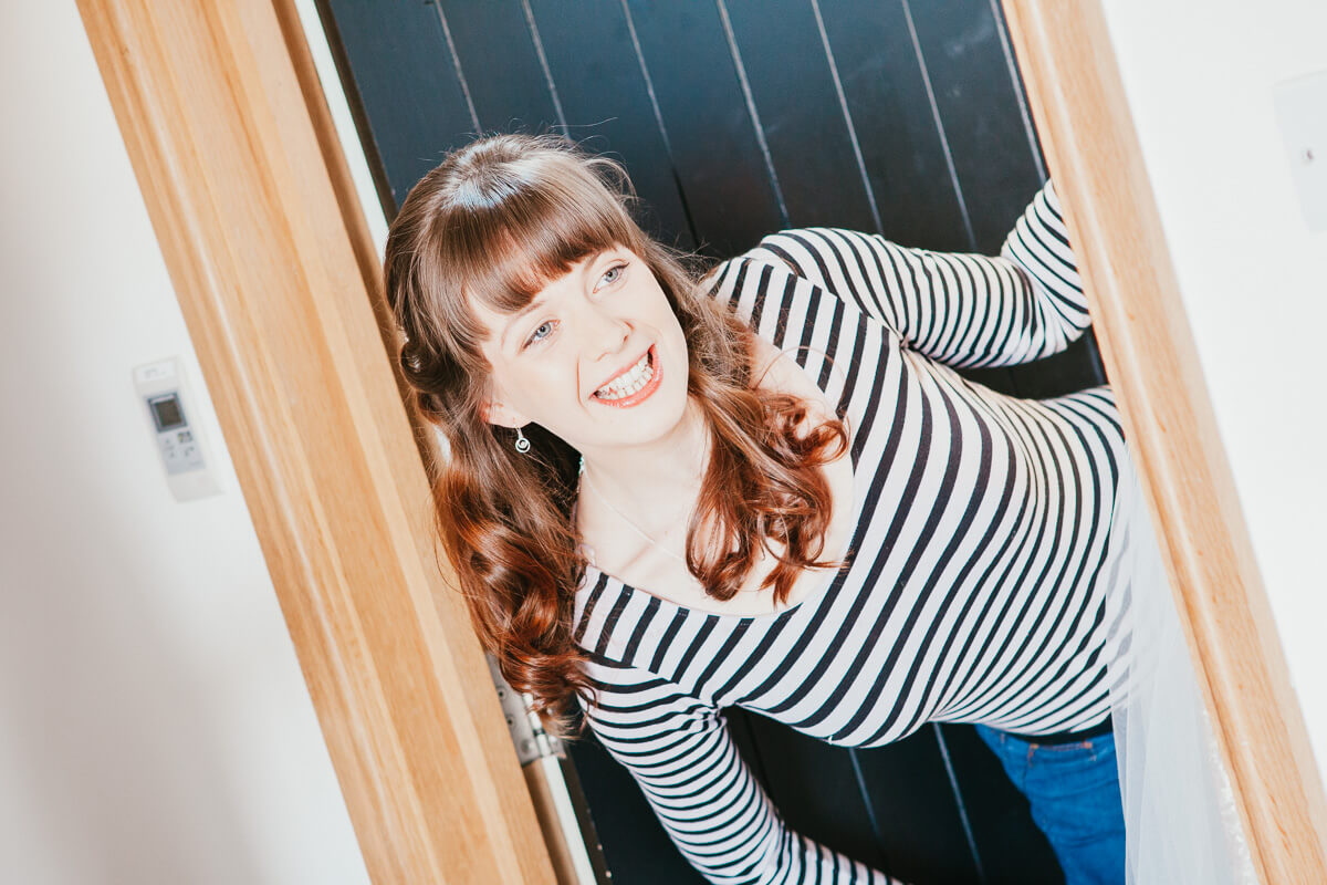 bridesmaid leaning out of doorway smiling