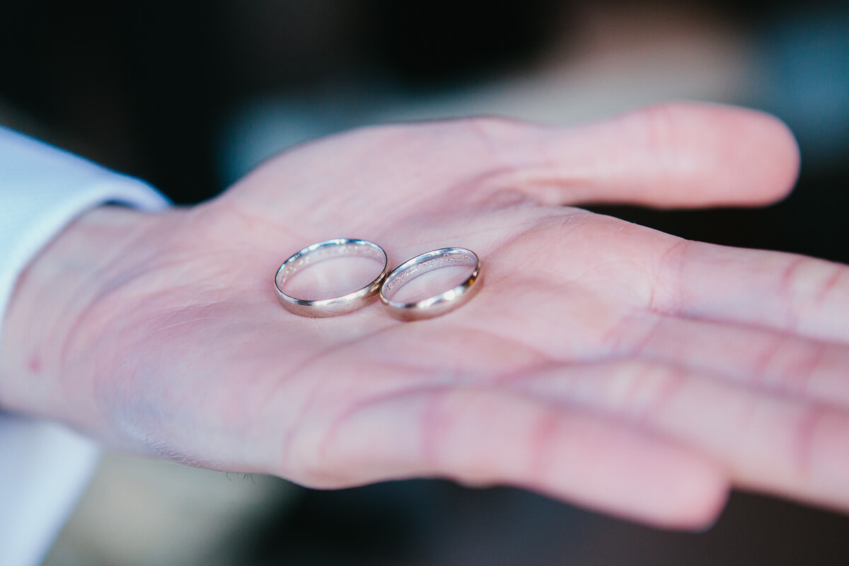 close up on hand holding rings