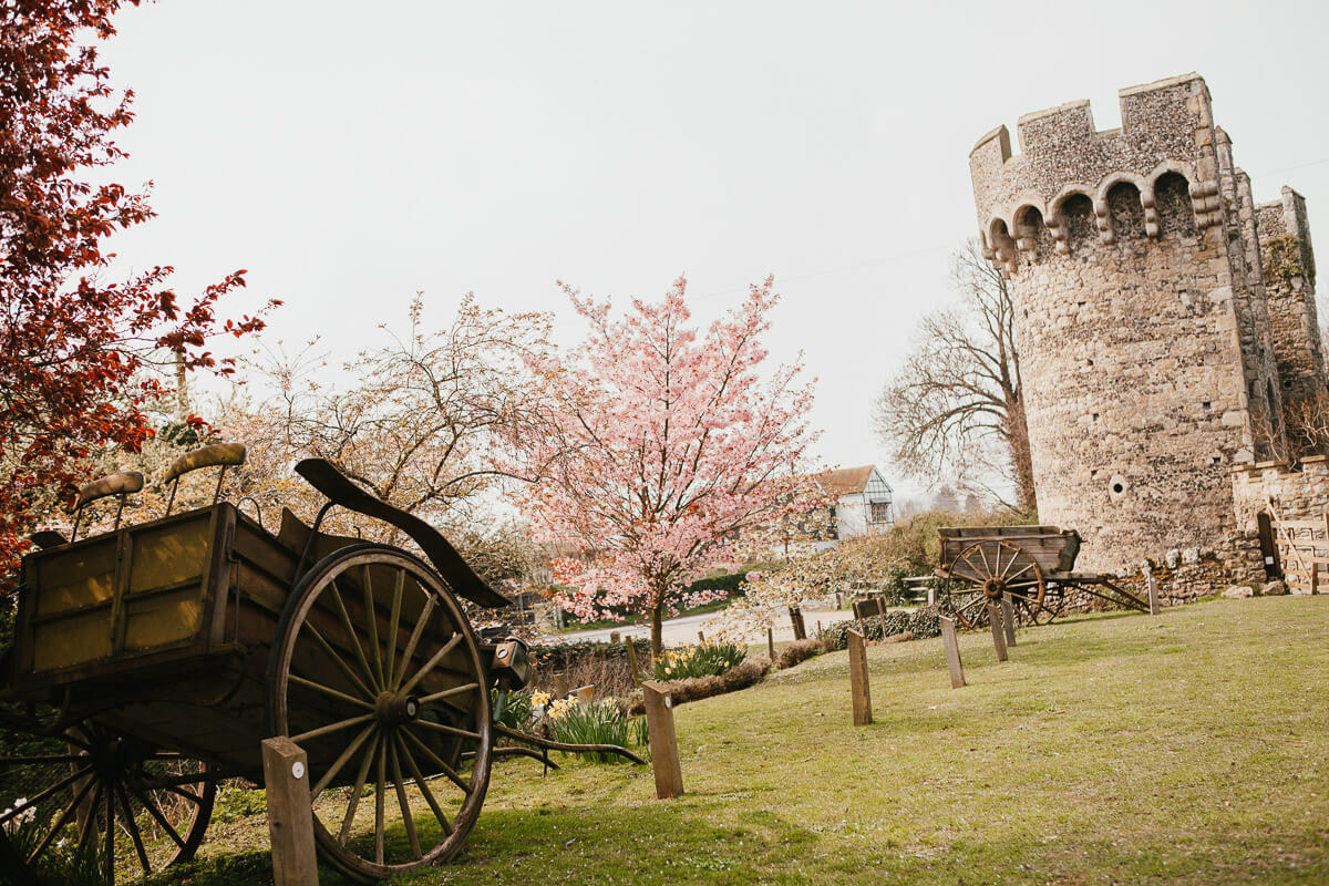 cooling castle grounds with castle turret and old cart in foreground