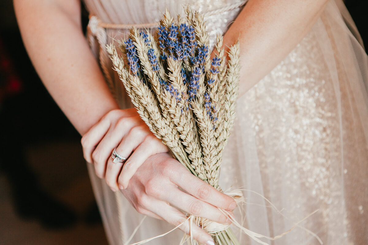 close up of lavender bouquet held by bridesmaid