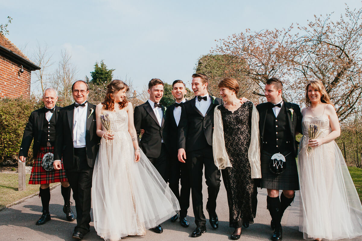 walking group shot of grooms and their friends