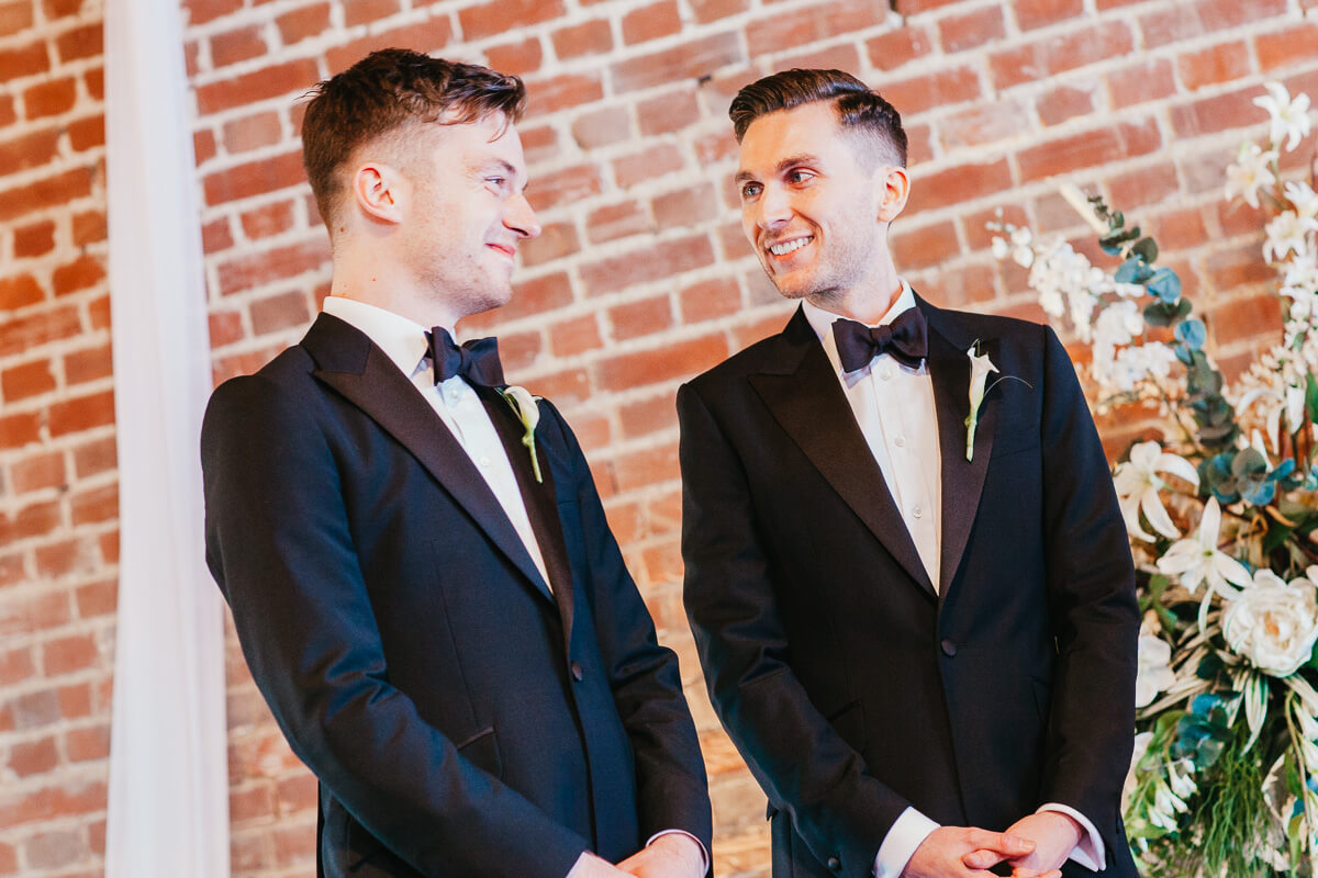 grooms looking at each other during vows