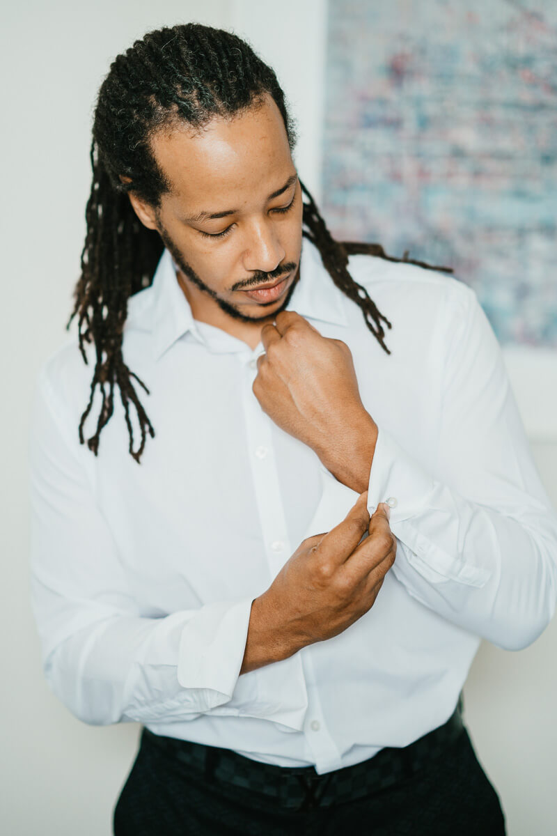 groom doing up his cufflinks