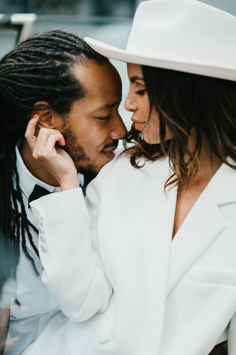 close up side portrait of couple with bride gently touch groom's ear