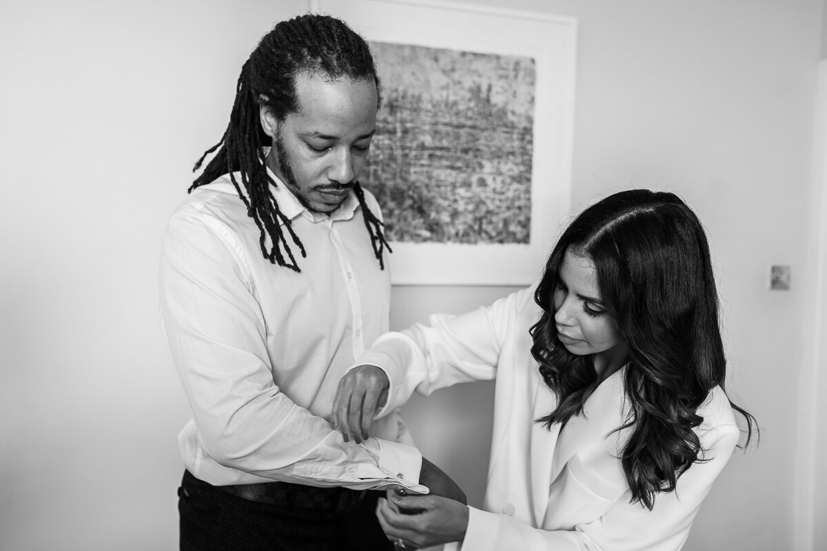 bride helping groom do up his cufflinks