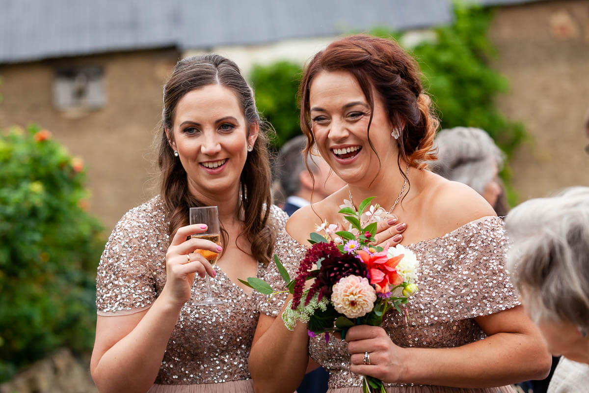 bridesmaids enjoying a laugh at the reception drinks