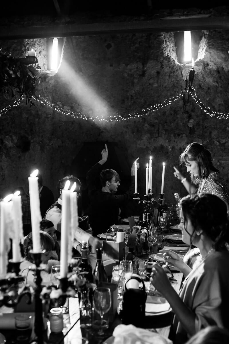 atmospheric shot of dining area in barn with misty light coming through on candlelit table