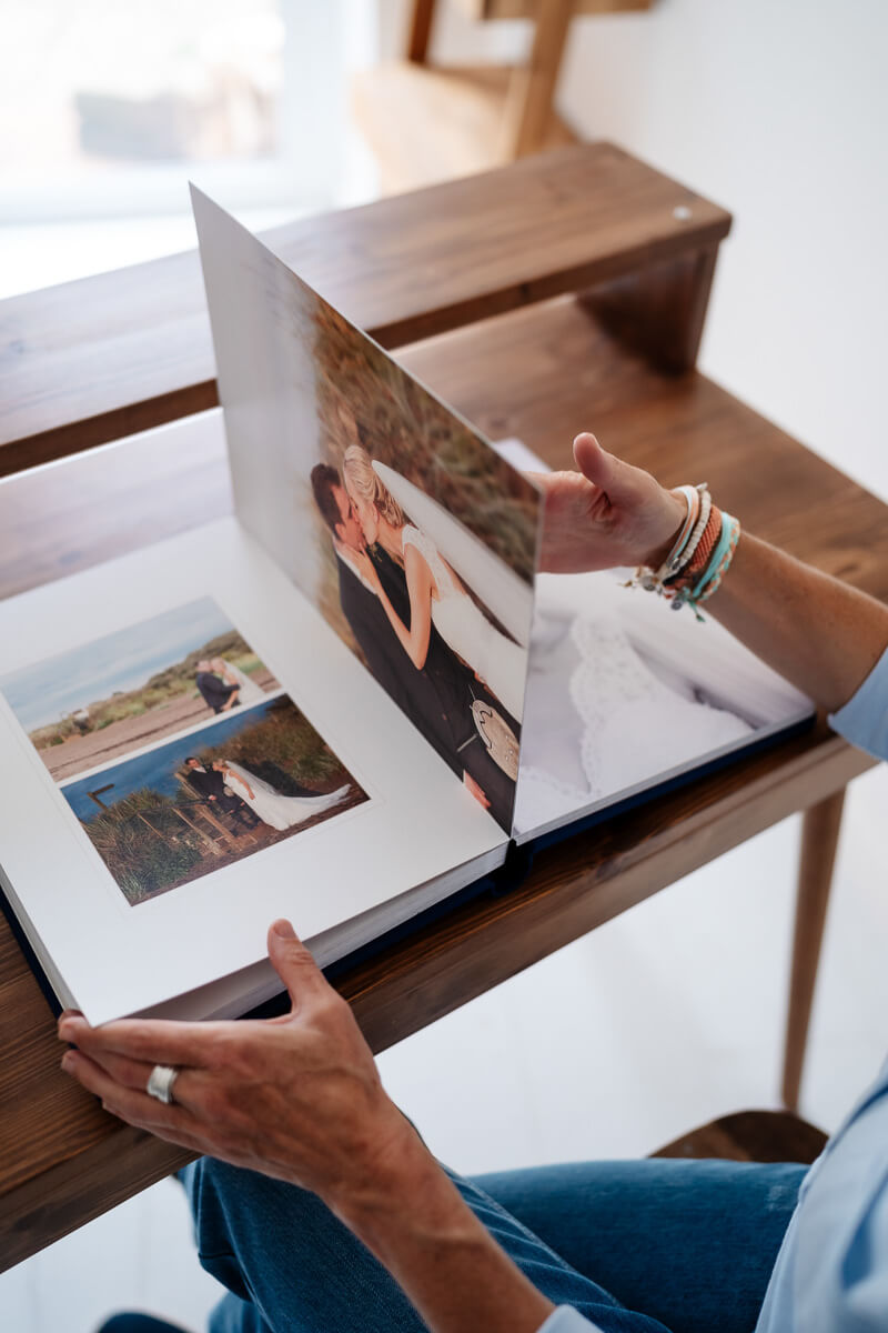 hands flicking through a professional wedding album