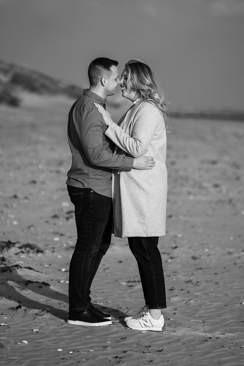 couple almost kissing standing with arms gently around each others waist