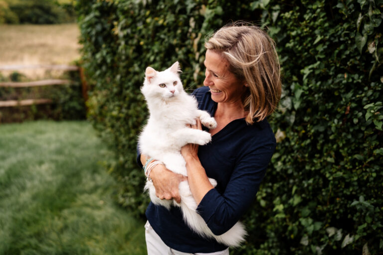 woman holding white cat
