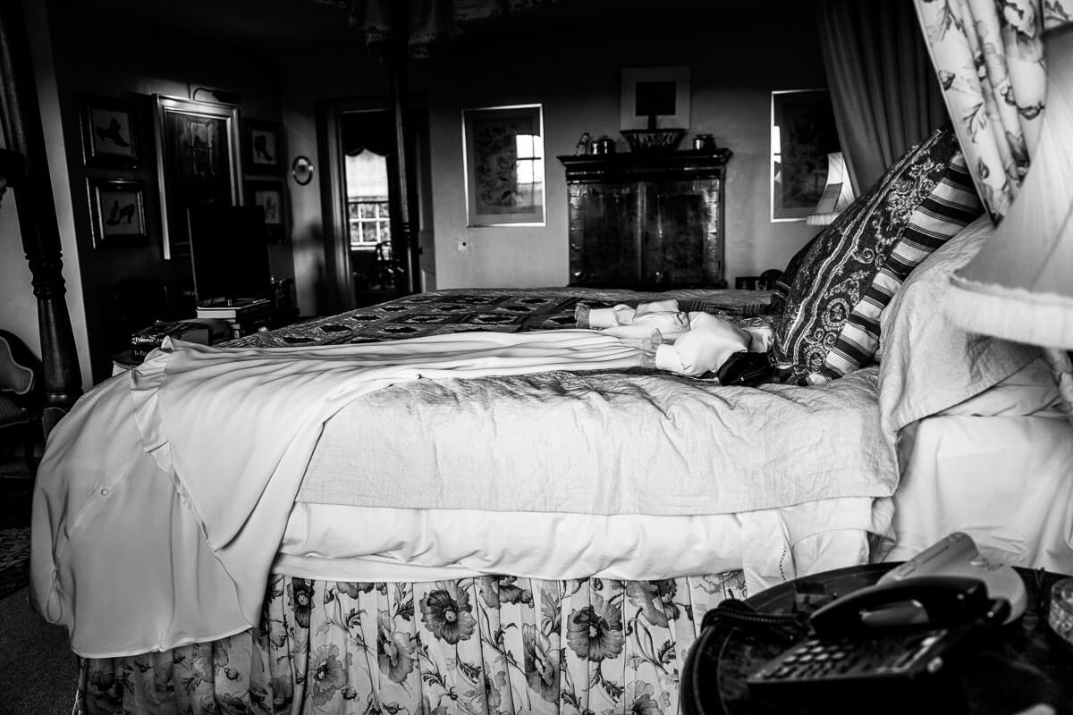 wedding dress laying on bed