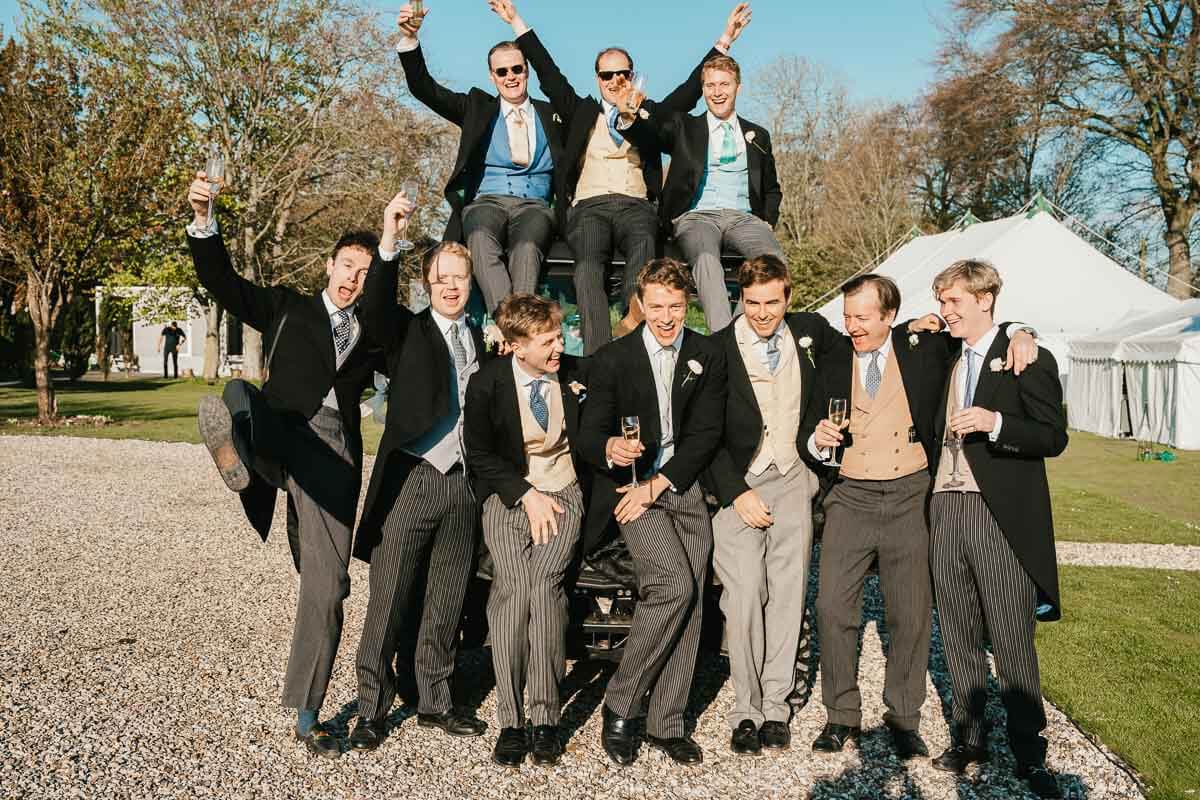 group shot of groomsmen pulling funny poses