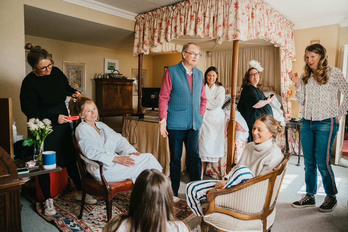 bridal party getting ready in large bedroom