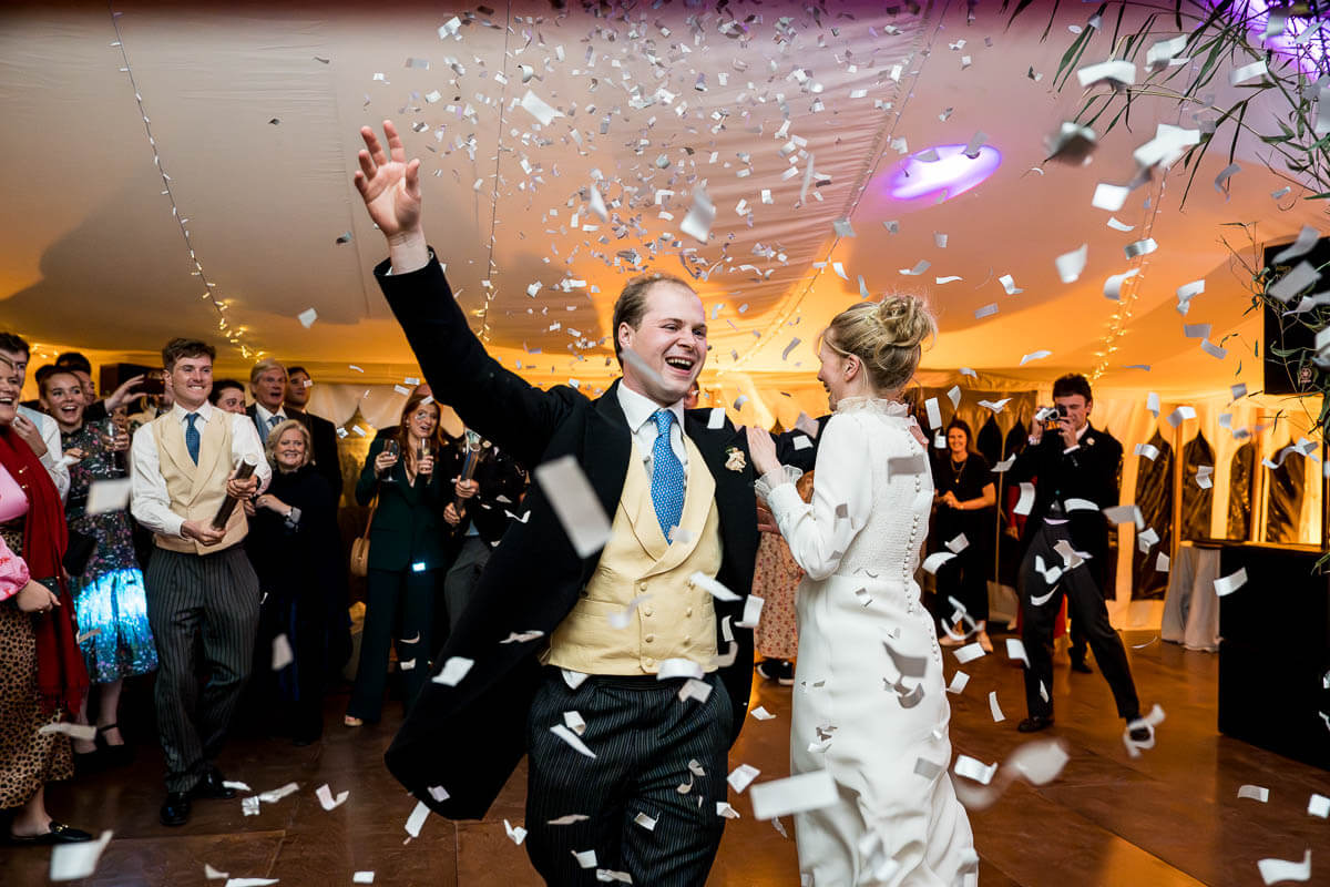 couple doing first dance with confetti bomb