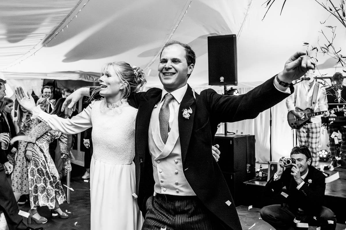 couple inviting guests onto the dance floor