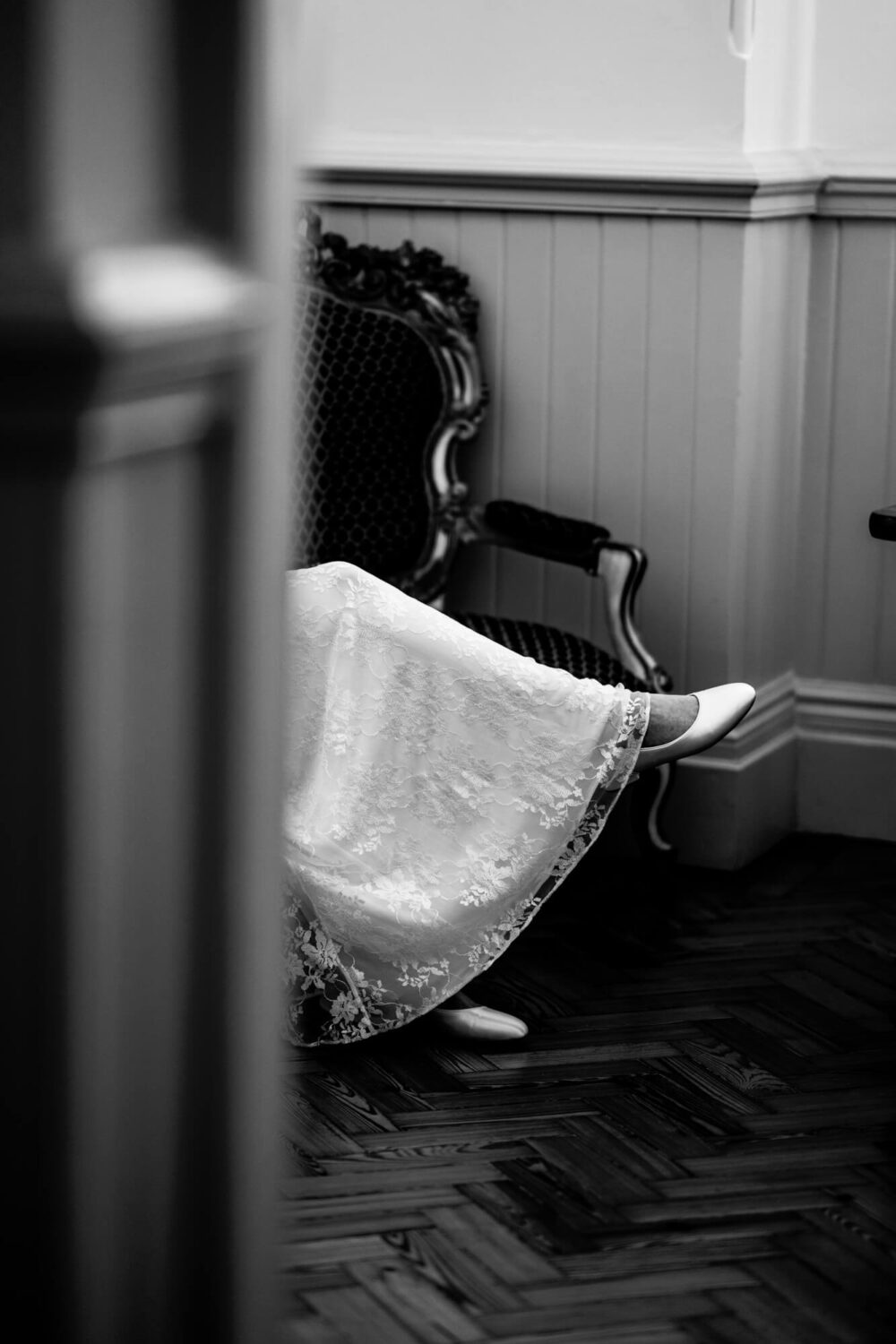 shot of bride's legs with rest of body hidden behind a pillar