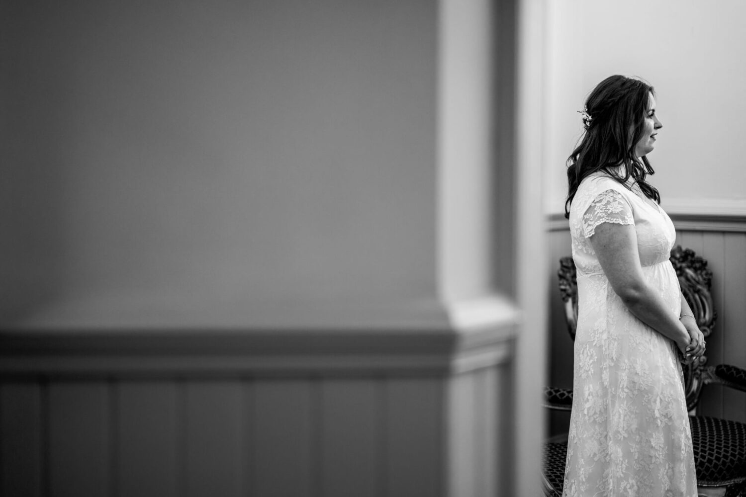 bride standing talking to registrar who is out of sight