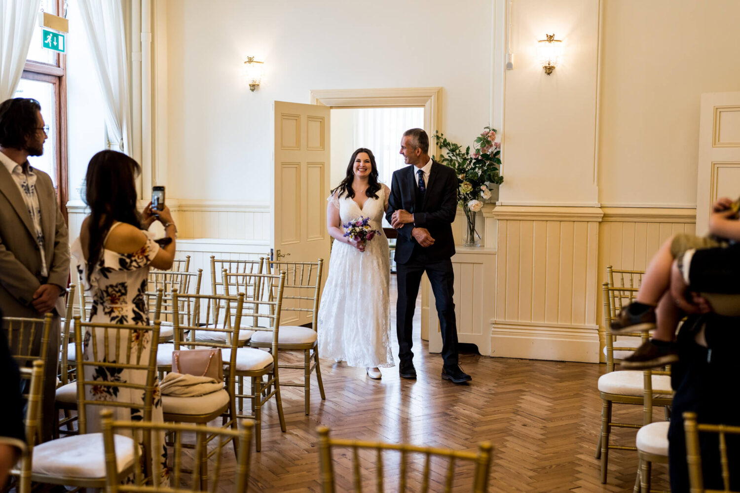 bride and father walking into ceremony room