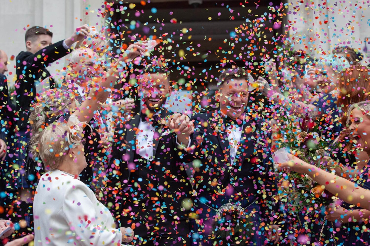 grooms walk out to so much confetti you can hardly see them