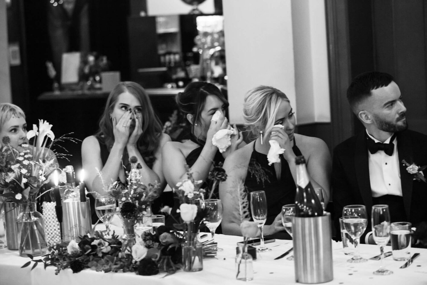 bridesmaids tearful during wedding speeches all with tissues