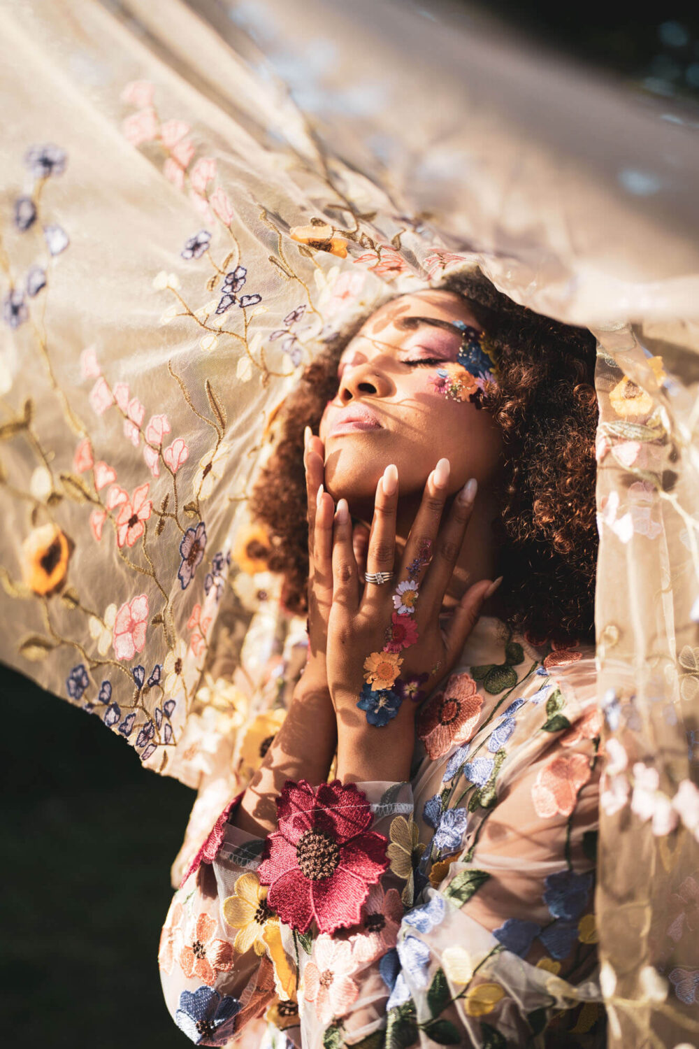 woman in bridal veil over her head with sun streaming through