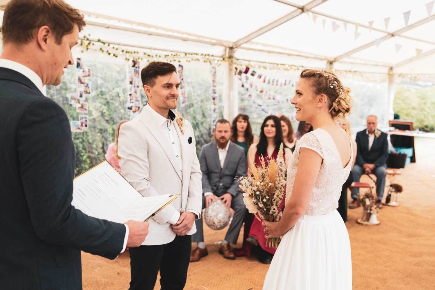 groom and bride standing with bride looking at celebrant and groom looking at her